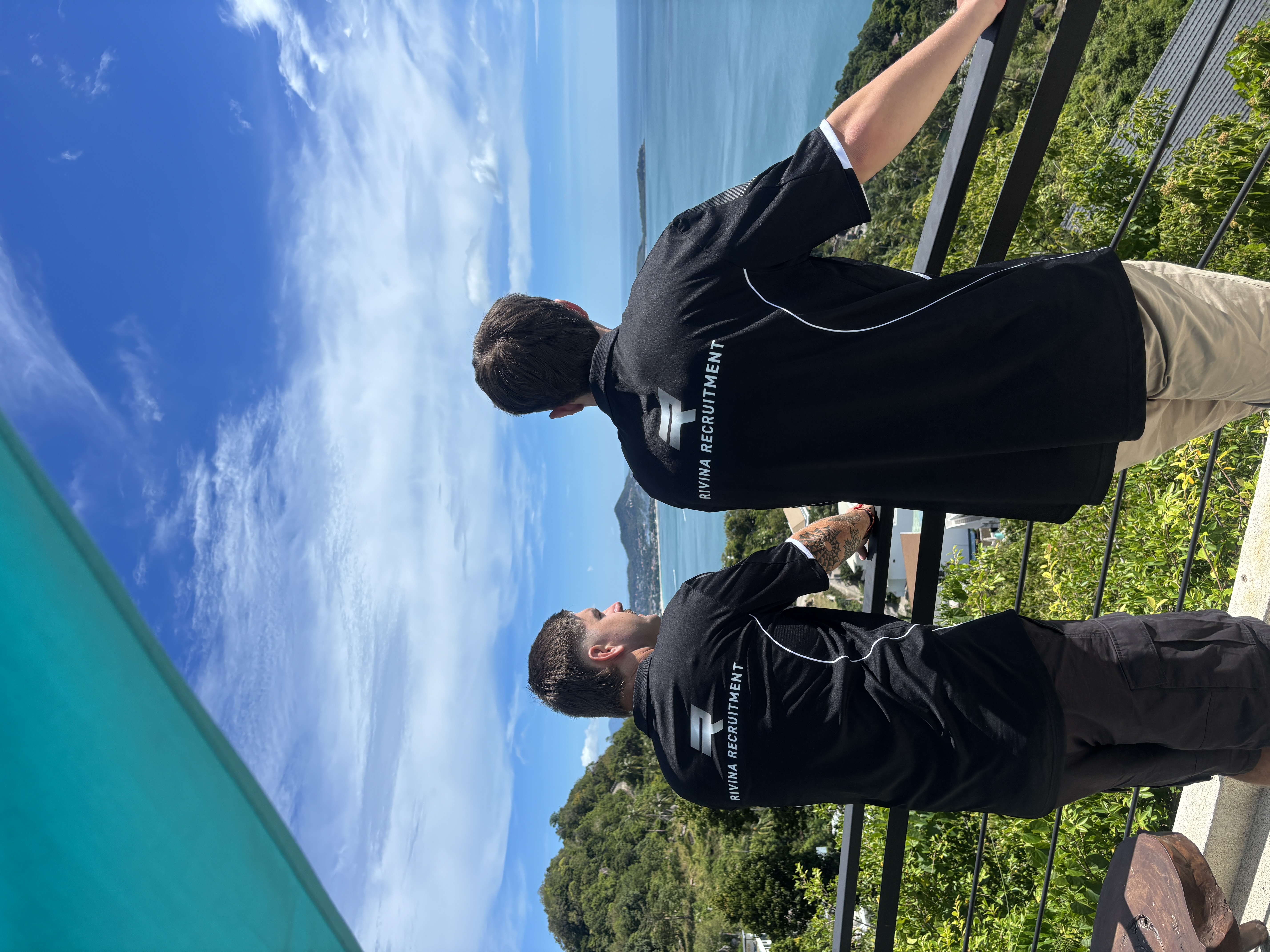 Rivina founders Flynn and Declan overlooking the coast in their Rivina Recruitment shirts